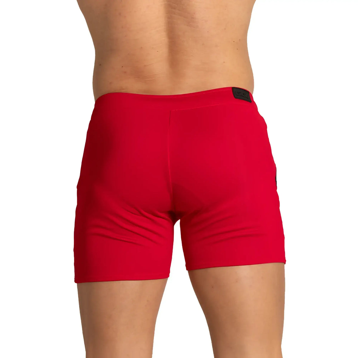 Red athletic training shorts with black brand tag at waistband designed for performance and comfort