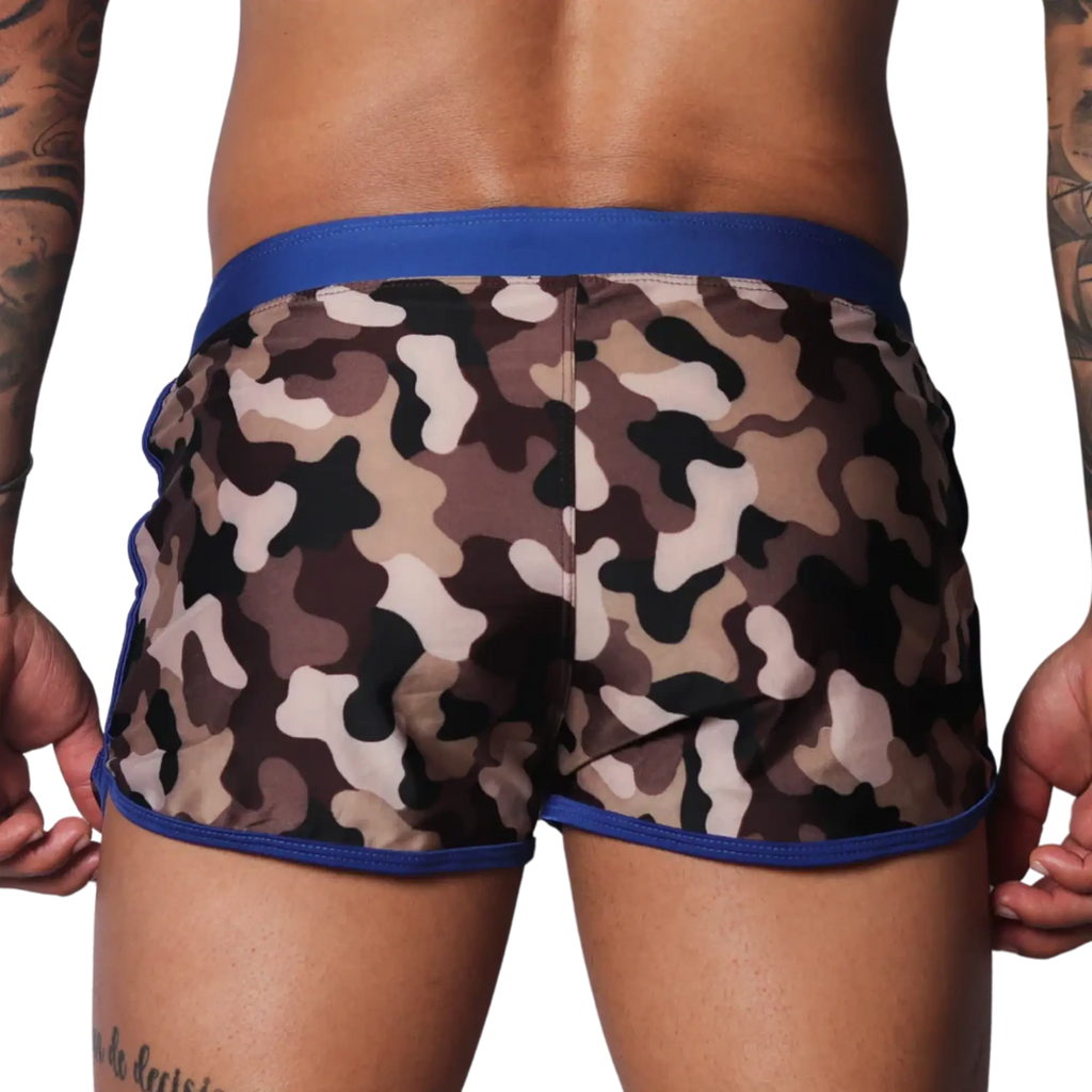 Men's camouflage beach shorts with a solid blue elastic waistband and blue trim on the curved side hems.