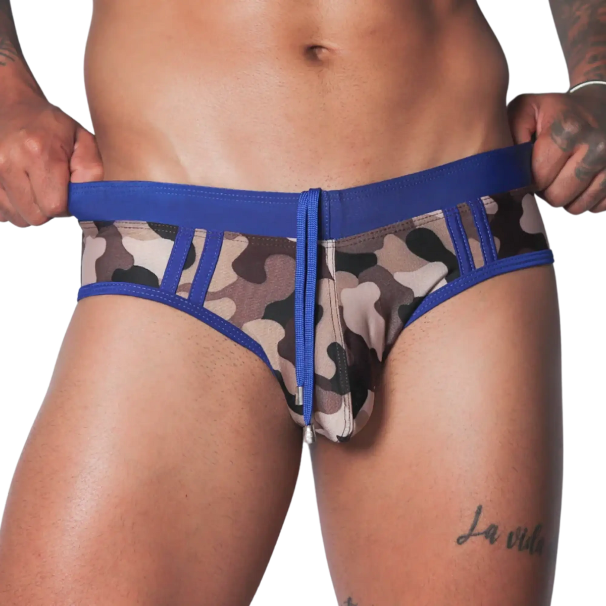 Blue camo swim brief with solid blue waistband, matching drawstring, and panel detailing on a fitted athletic cut.