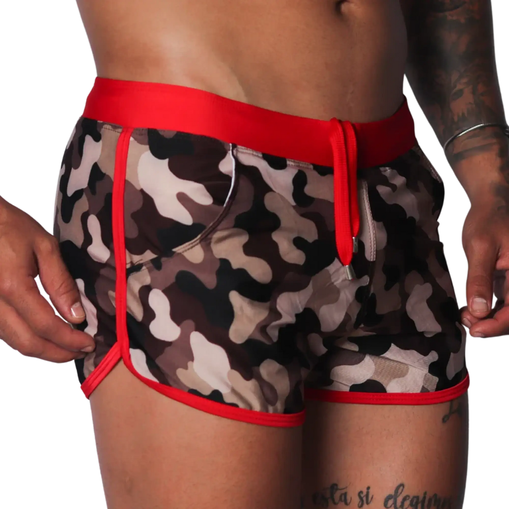 Men's camouflage print swim shorts with red trim, elastic waistband, and matching drawstring.