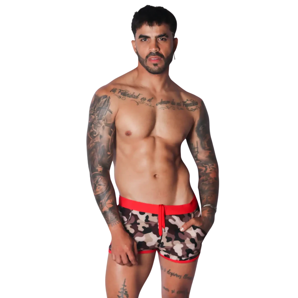 Men's camo print beach shorts featuring a bold red elastic waistband, matching red trim, and a drawstring front.