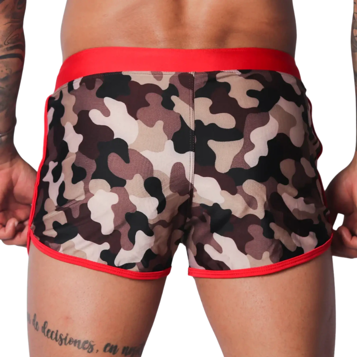 Short camo-print swim trunks with a wide red waistband and red piping trim along the leg openings.