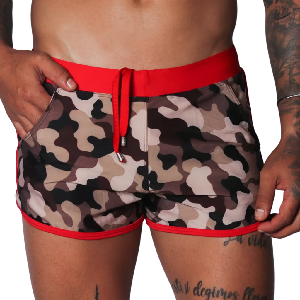 Men's camo beach shorts with red trim, drawstring waistband, and side pockets in a short athletic fit.