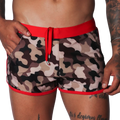 Men's camo beach shorts with red trim, drawstring waistband, and side pockets in a short athletic fit.