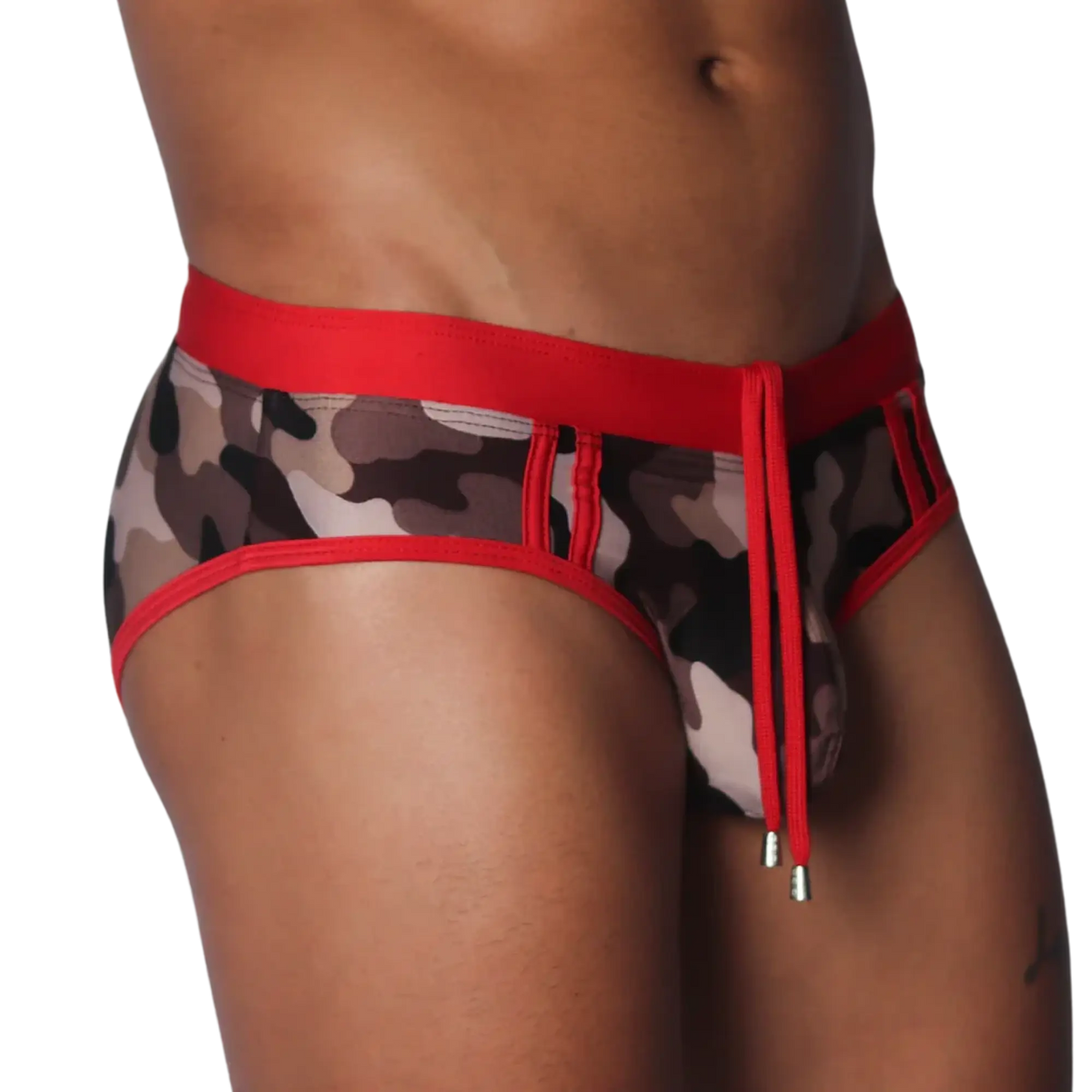 Sheer camo print swim brief with a red elastic waistband, matching trim, and front drawstring with metallic toggles.