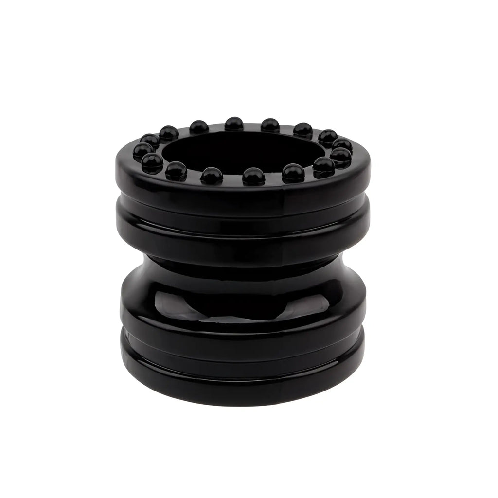 Black glossy plastic ashtray with a circular rim adorned by small black spherical beads from GK Power ring set