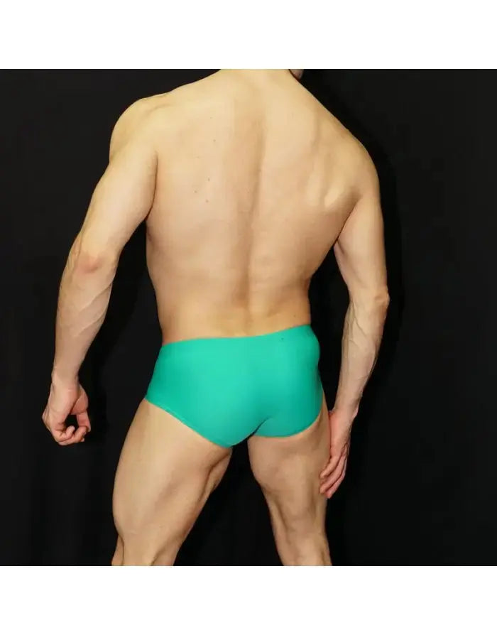 Men's green Brazilian sunga by Arroyman featuring a snug fit and smooth fabric shown from the back against a black background.