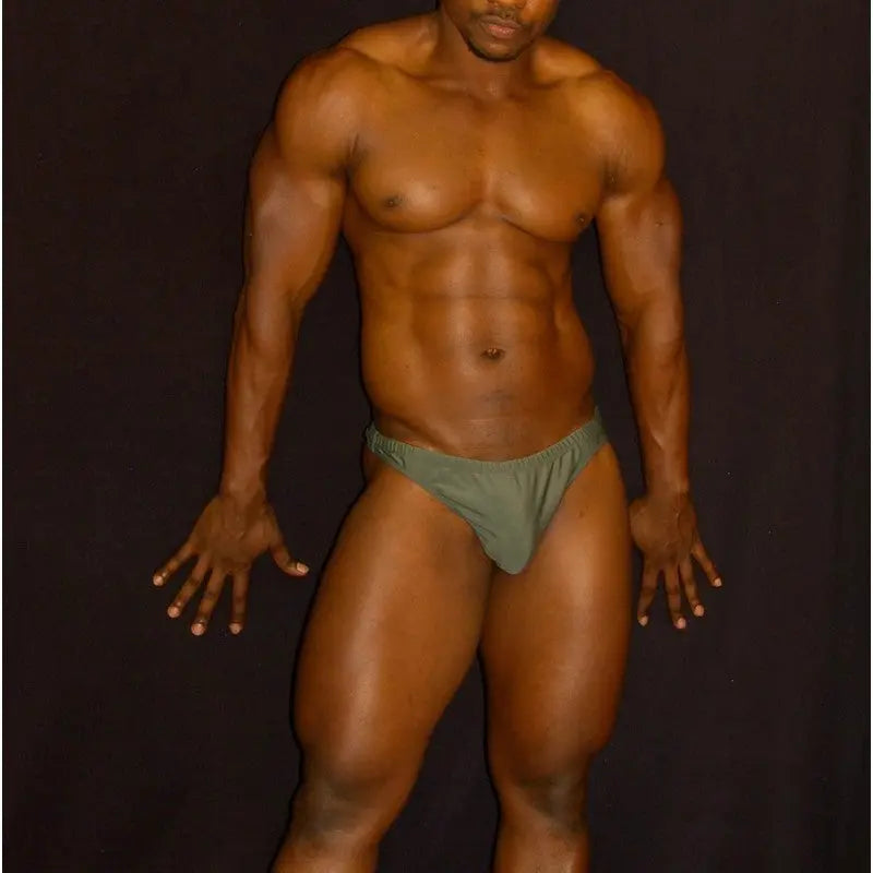 Olive green swimwear thong by Arroyman featuring a snug fit and minimal coverage modeled by a male figure.