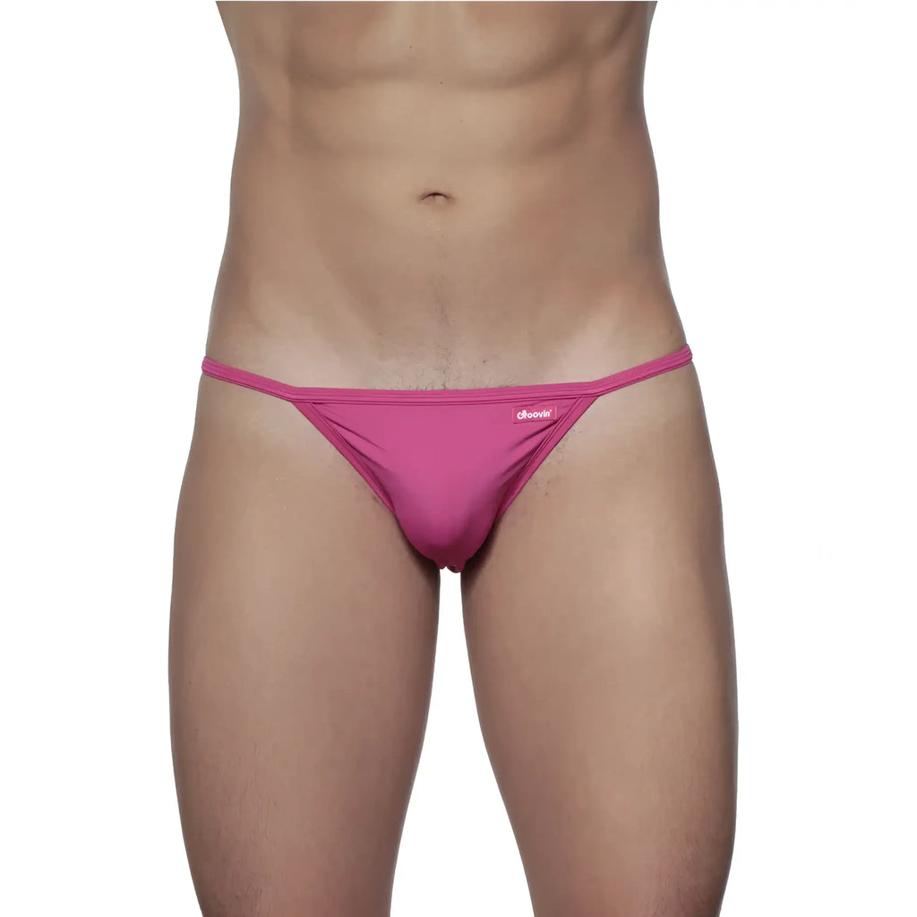 A vibrant pink groovin string bikini fuchsia pink st0116 thong made of smooth fabric with a small brand tag on the waistband