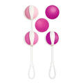 Set of pink and white silicone gvibe geisha balls with a looped handle designed for discreet pelvic exercise