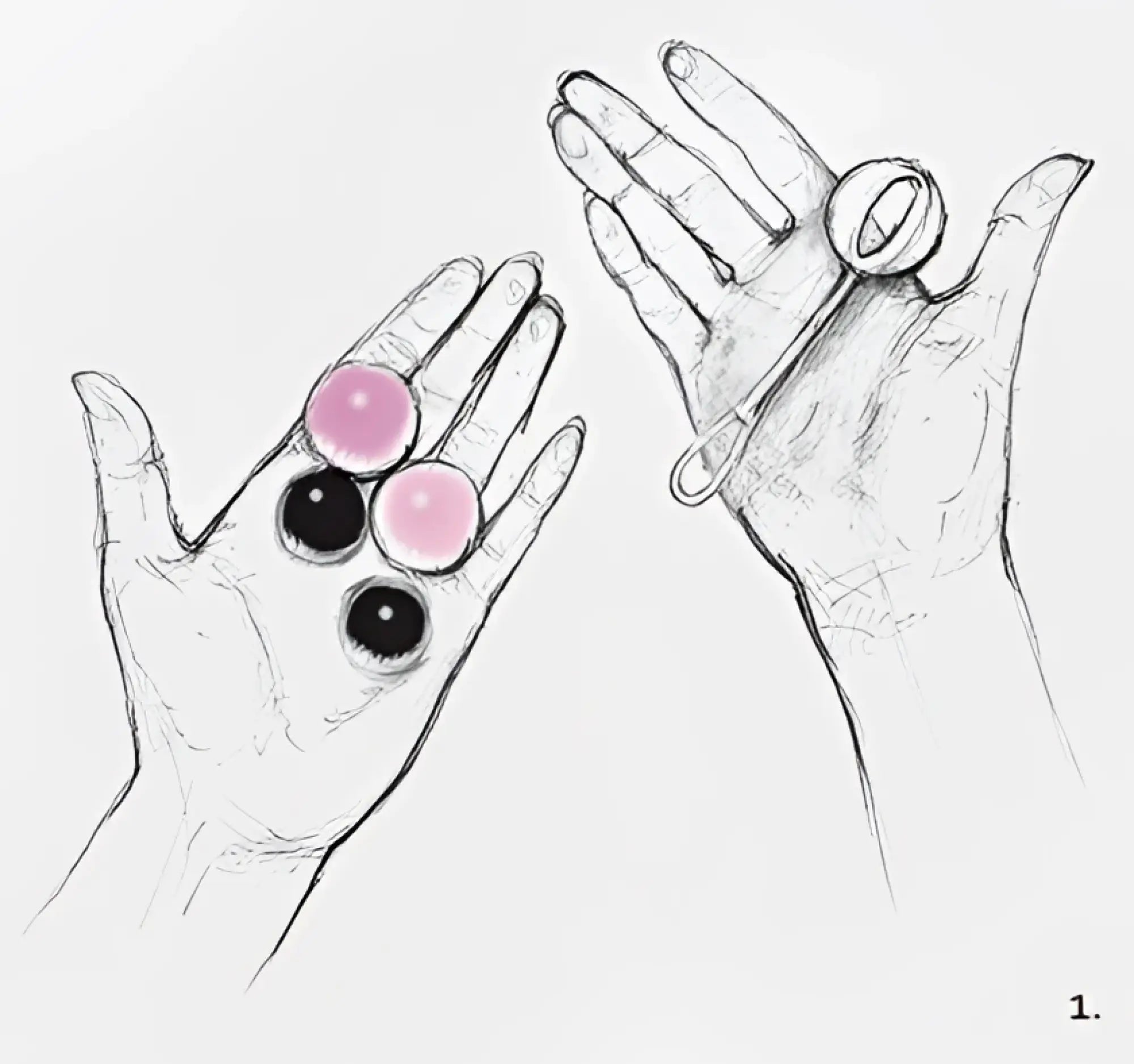 A hand holding four magnetic gvibe geisha balls in pink and black with a matching baby rattle for pelvic exercise