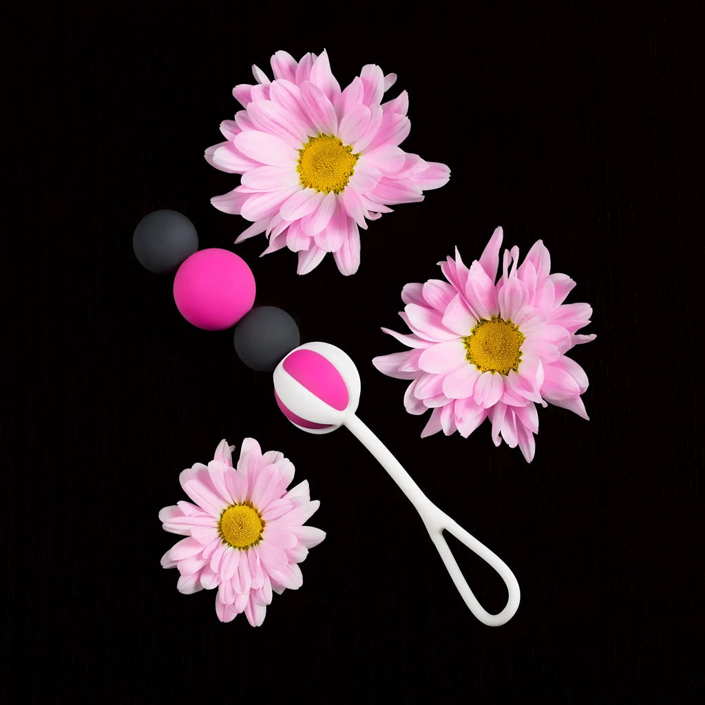 Pink and black silicone gvibe geisha balls magnetic set with white handle featuring pink accents for intimate use