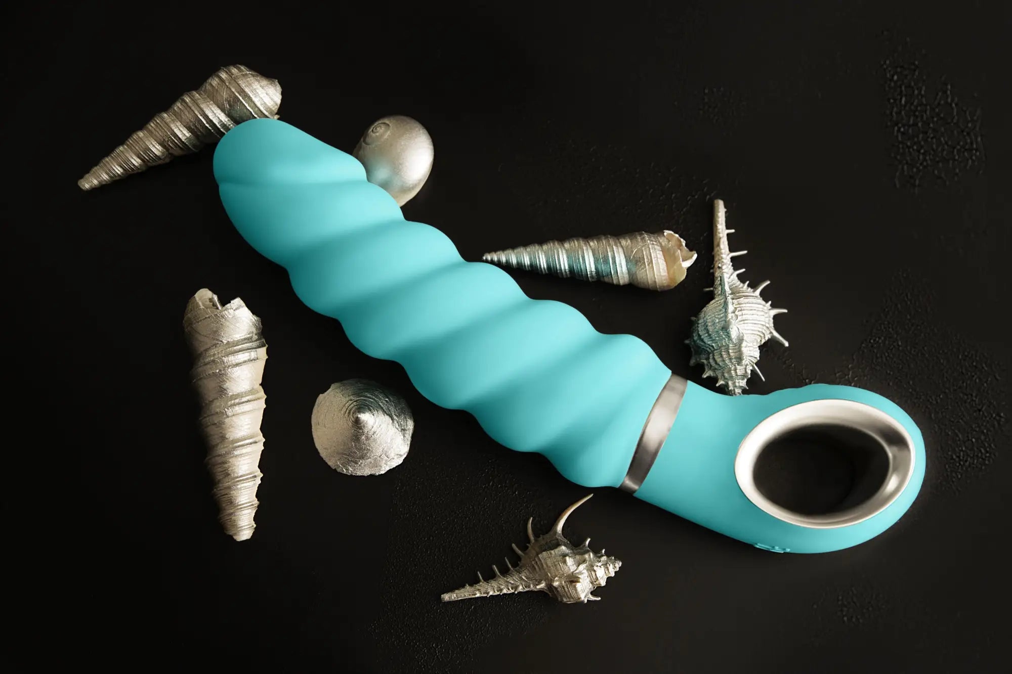 Turquoise silicone-coated gjack 2 spiral adult toy with silver metallic ring and handle for intimate use