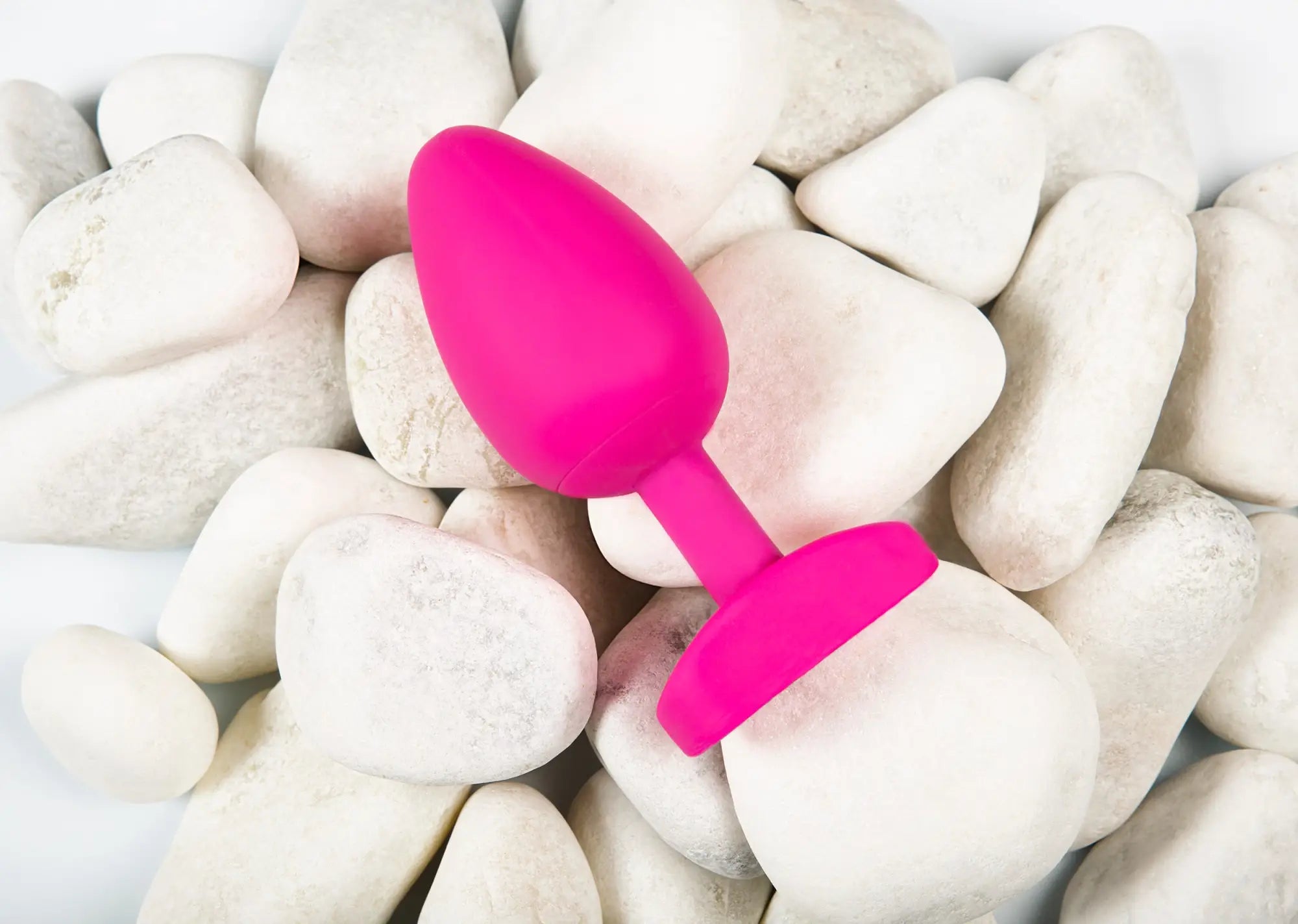 A vibrant pink silicone anal plug with a smooth rounded head and flat base from Gvibe Gplug large bioskin sweet raspberry