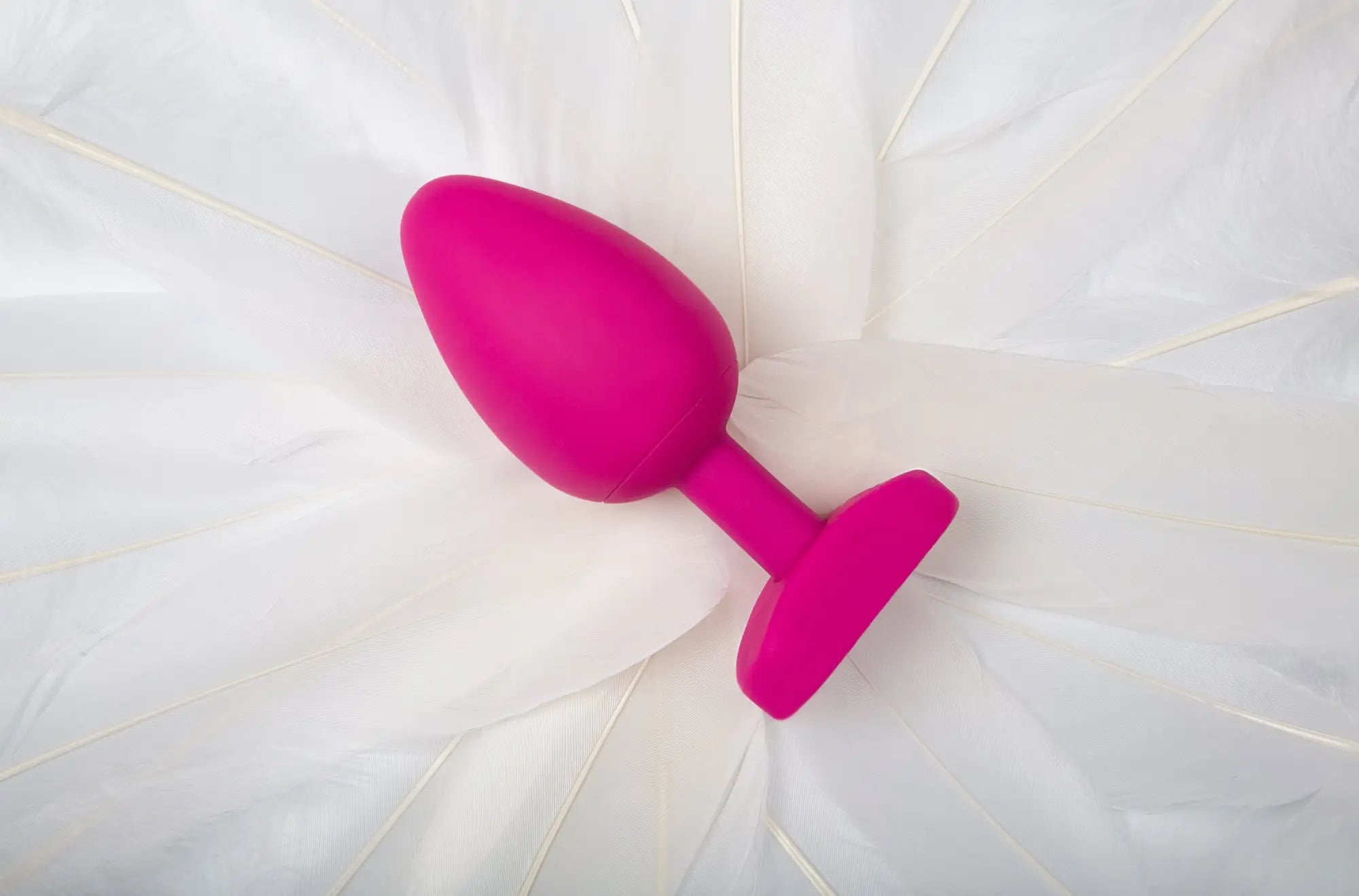 A vibrant pink silicone butt plug with smooth rounded head and flat base from Gvibe Gplug large bioskin sweet raspberry
