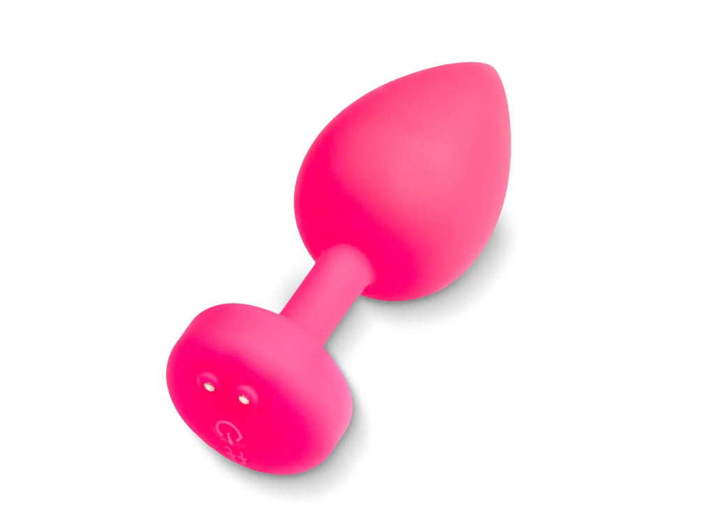 Bright pink silicone butt plug with teardrop-shaped head and circular base with two holes gvibe gplug large neon rose