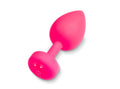 Bright pink silicone butt plug with teardrop-shaped head and circular base with two holes gvibe gplug large neon rose