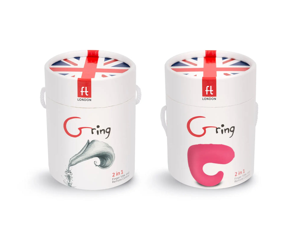 Two white cylindrical ft london containers with union jack lids displaying silver ring and pink c shaped g-ring designs