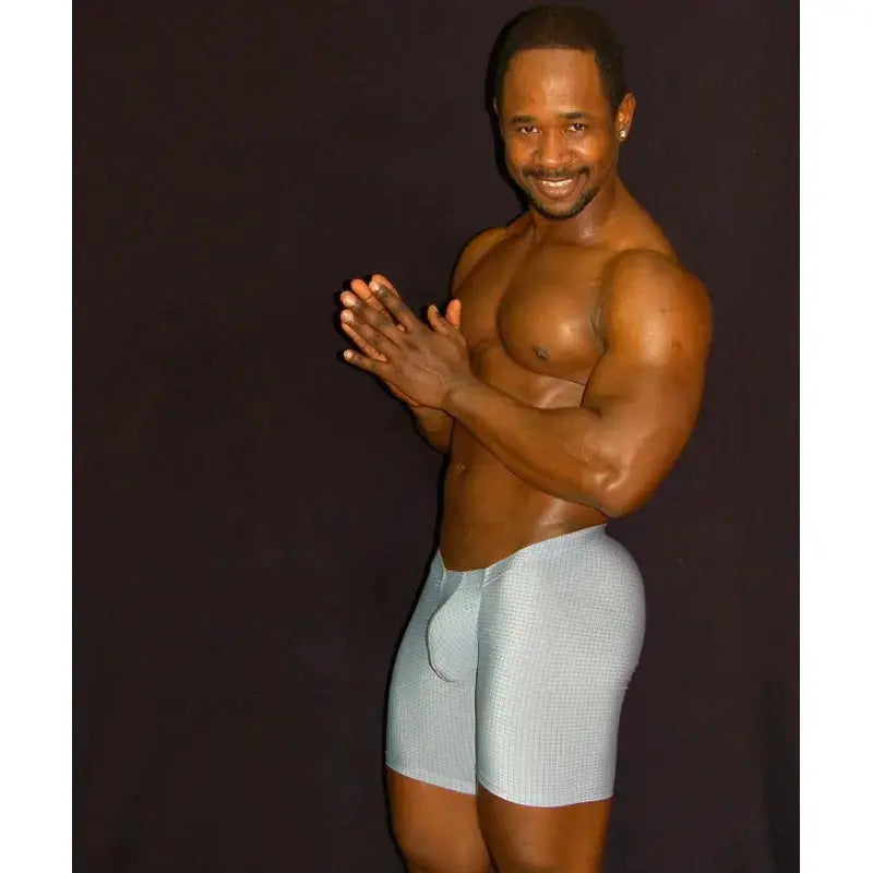 Gray gym shorts with a fitted design made of stretchy material shown on a muscular model by Arroyman.