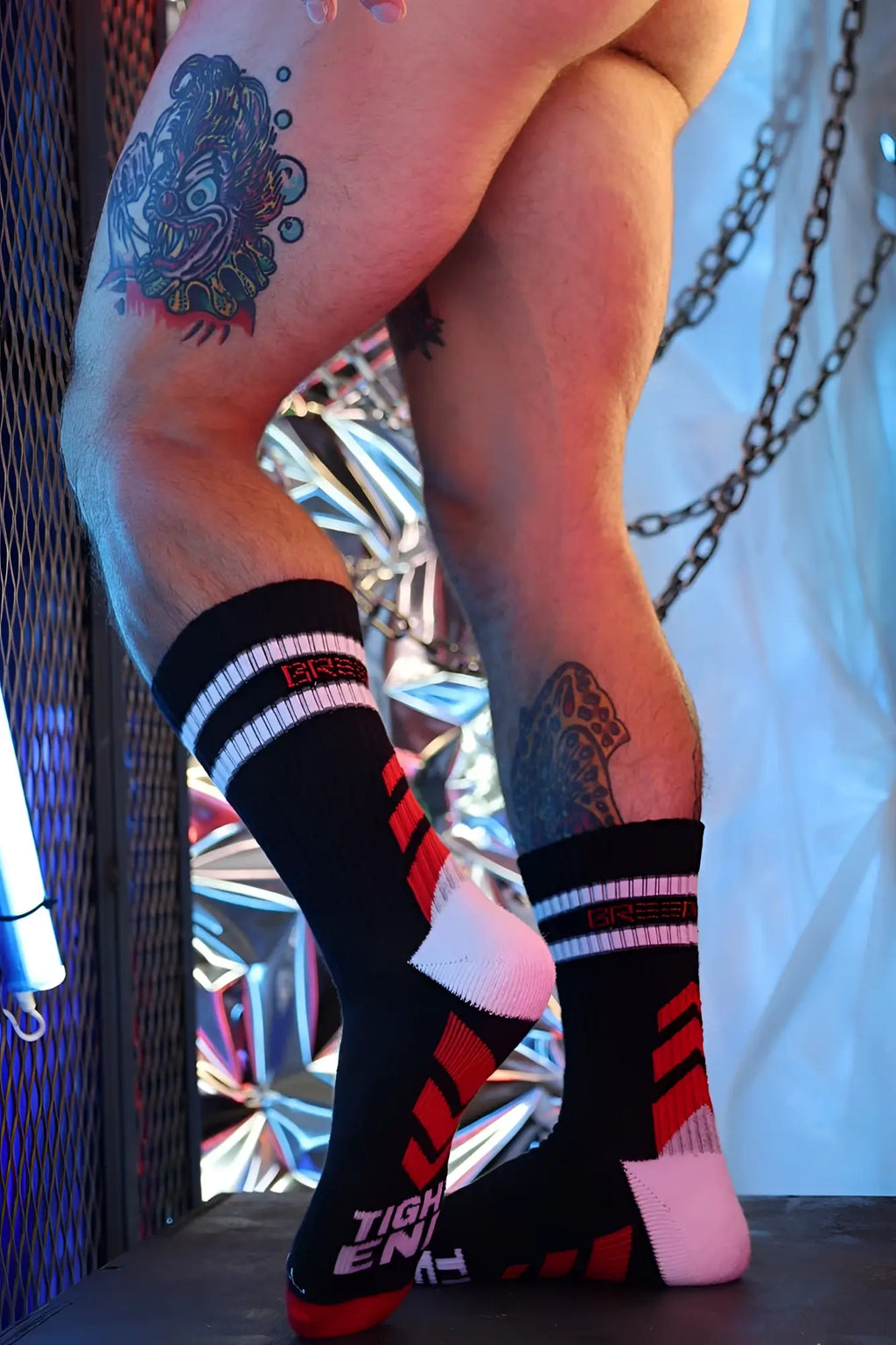 Black gymnetixxx crew socks with red white accents and pink tight enough design on the heel back side