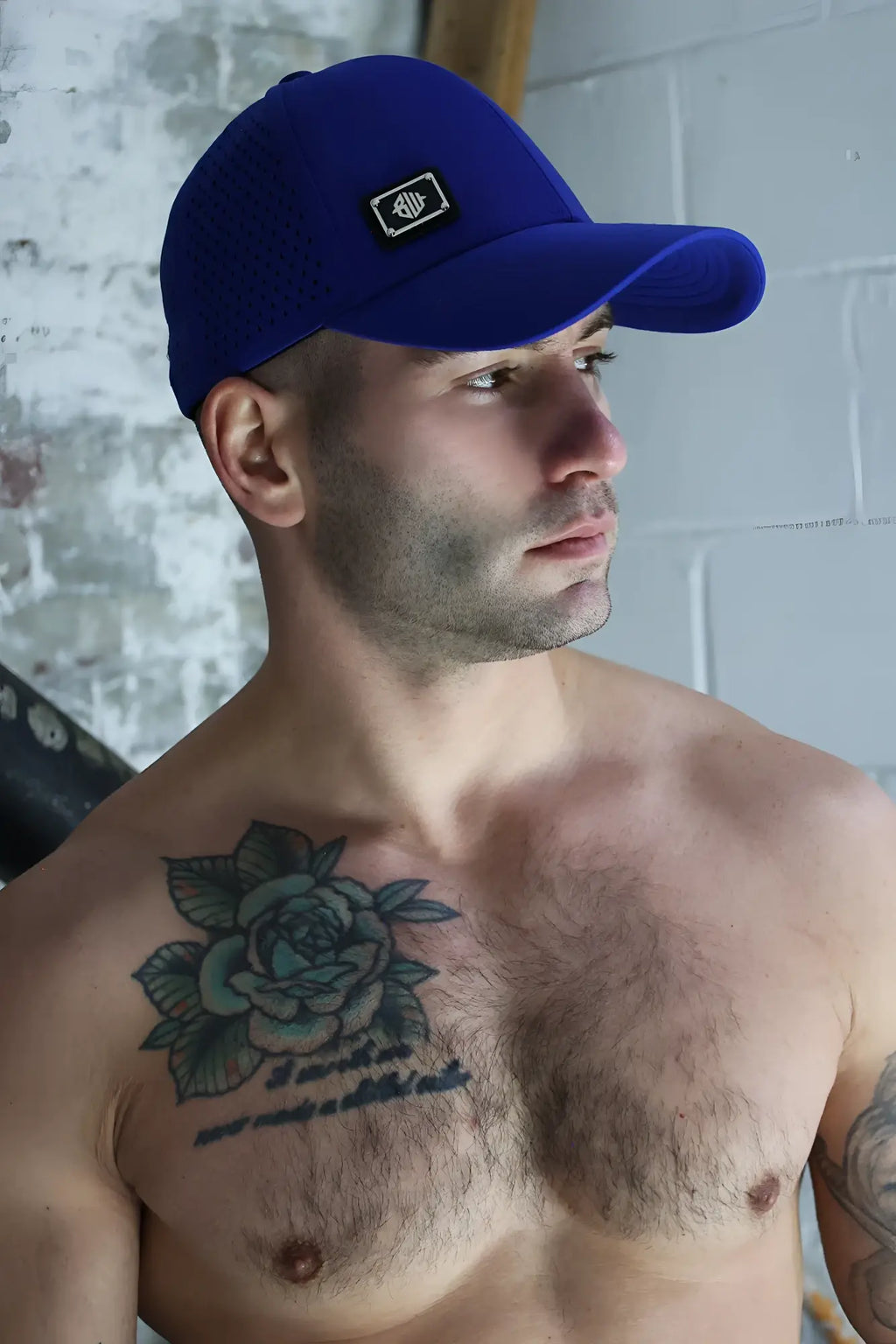 Royal blue gymnetixxx baseball cap with small black and white embroidered logo on front for casual wear