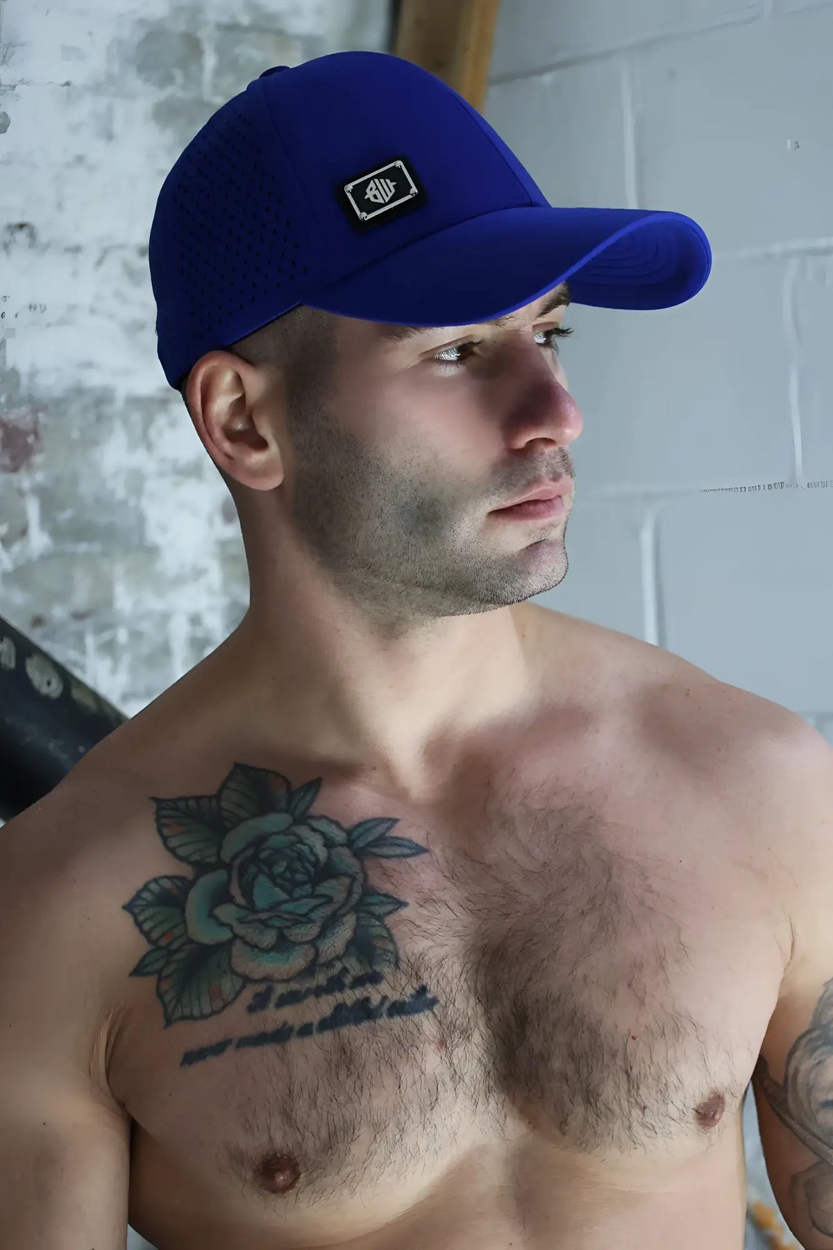 Royal blue gymnetixxx baseball cap with small black and white embroidered logo on front for casual wear