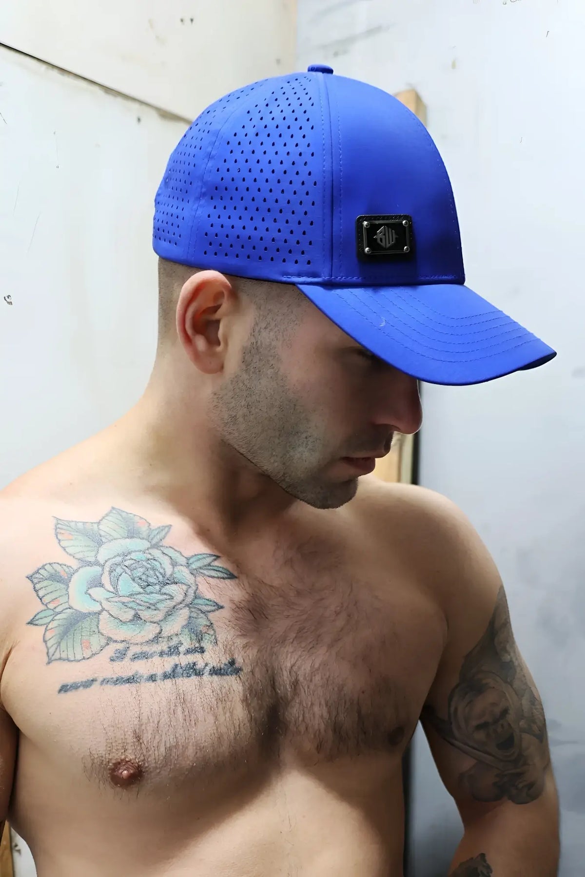 Vibrant royal blue perforated gymnetixxx baseball cap with a black rectangular logo patch on the front