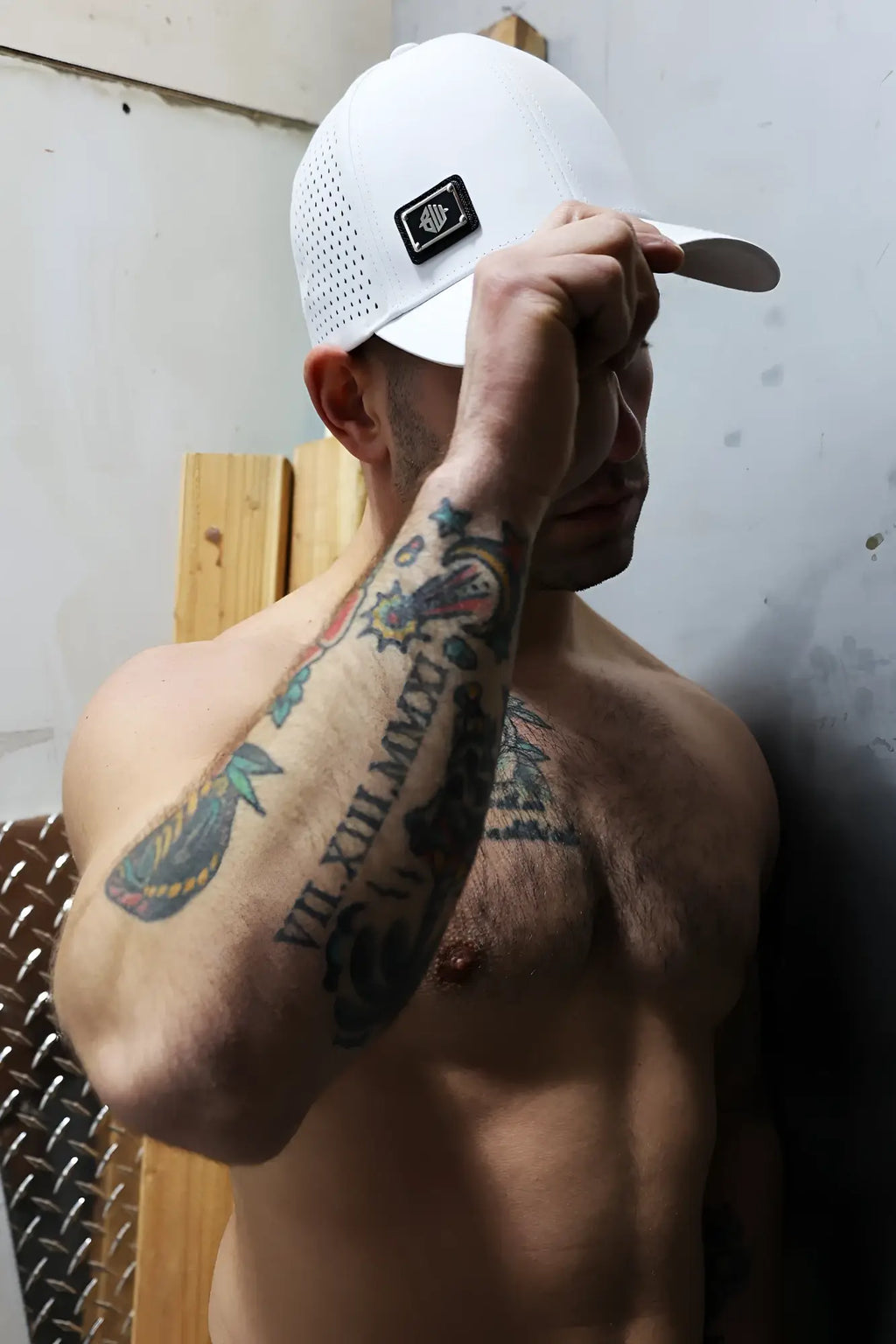 White perforated baseball cap with black embroidered logo patch gymnetixxx hat for active wear