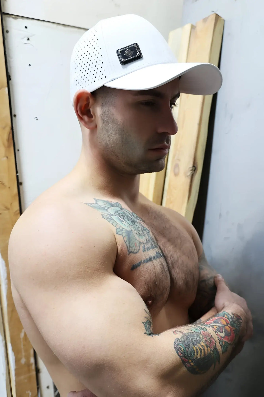 White perforated baseball cap featuring a black rectangular Gymnetixxx logo patch for athletic use