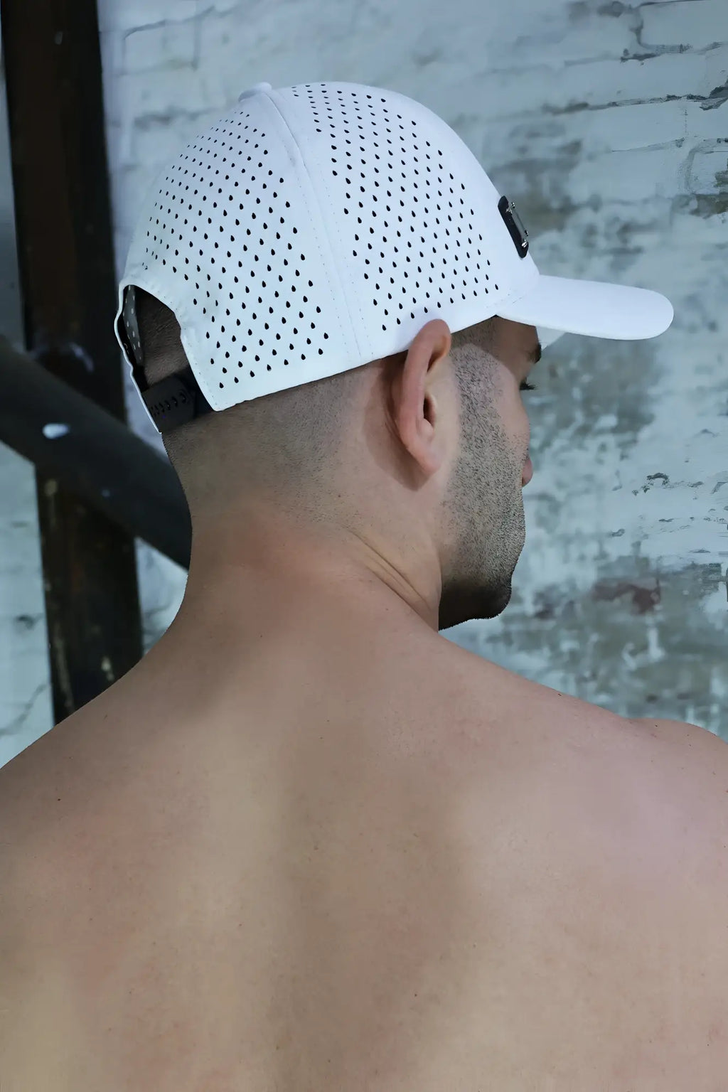 White perforated baseball cap with structured crown and curved brim from gymnetixxx hat collection