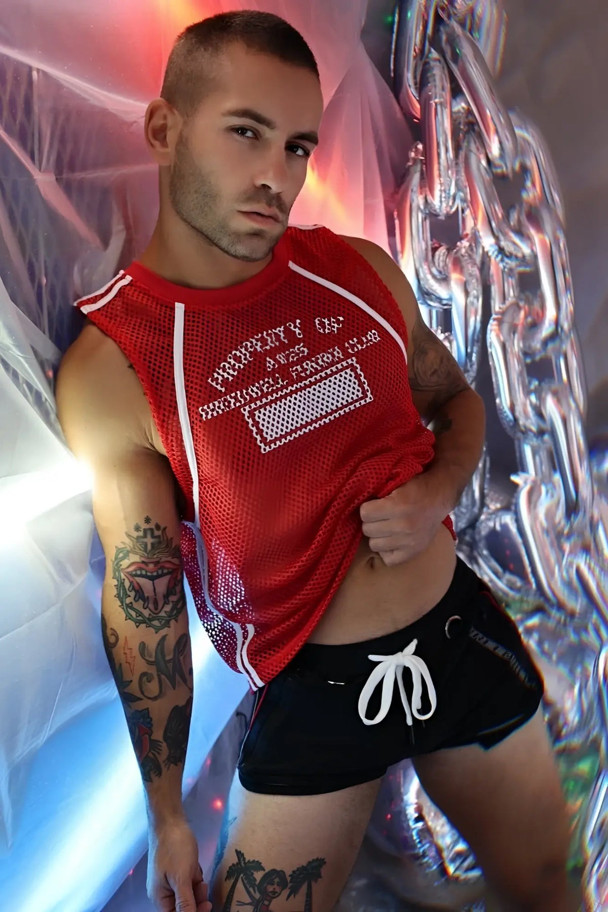 Red mesh sleeveless gymnetixxx jersey top with white trim and embroidered text for athletic wear