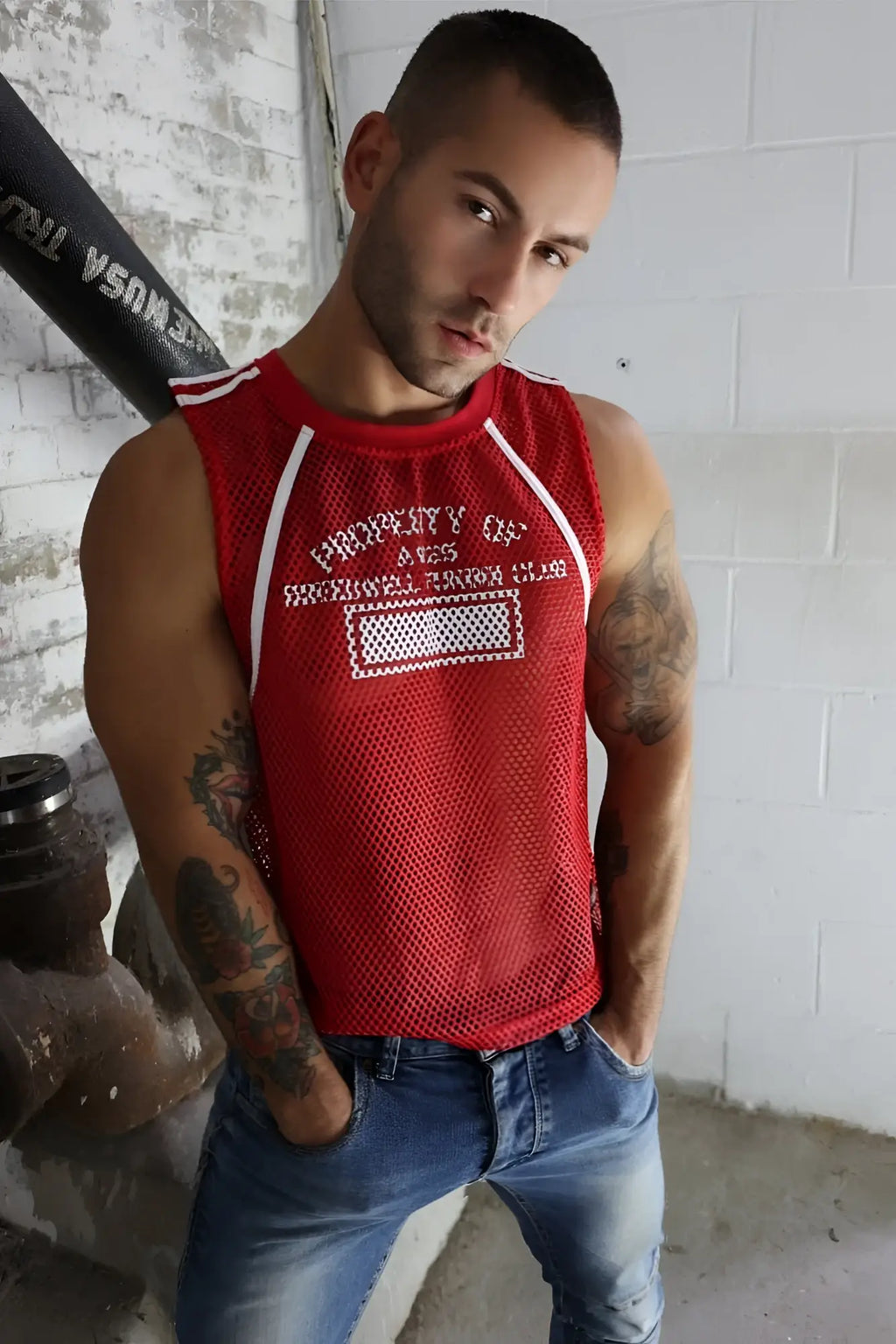 Red mesh tank top gymnetixxx jersey with white trim and embroidered property of text above a rectangular patch