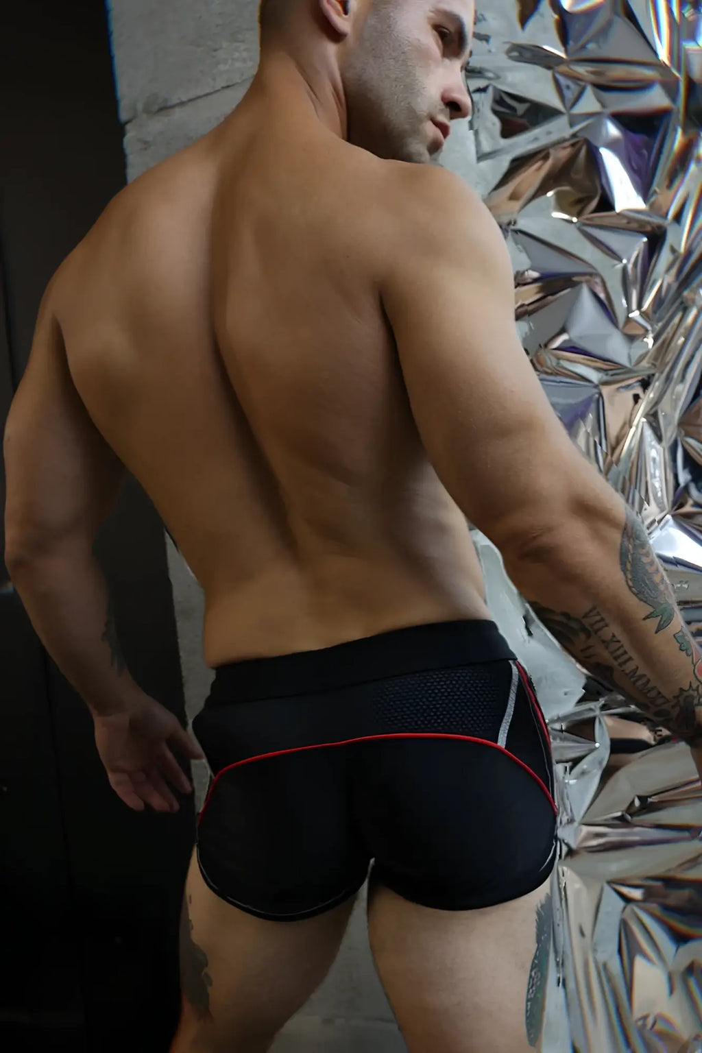 Black gymnetixxx athletic shorts with red and white trim designed for workout and sports activities