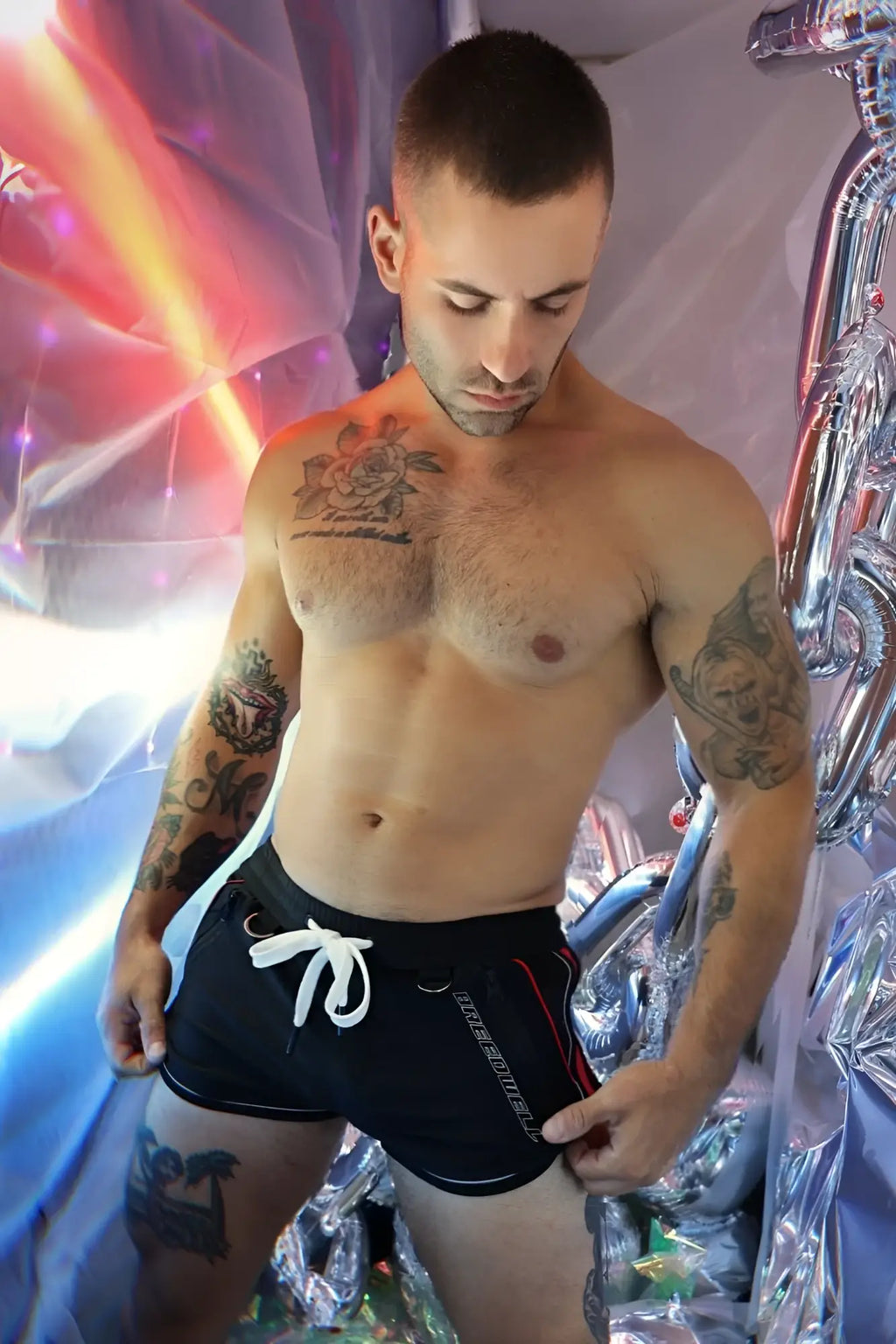 Black gymnetixxx athletic shorts with white drawstring and red side stripe designed for workout comfort