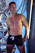 Black Gymnetixxx swim trunks with white drawstring and red side stripes designed for active water sports