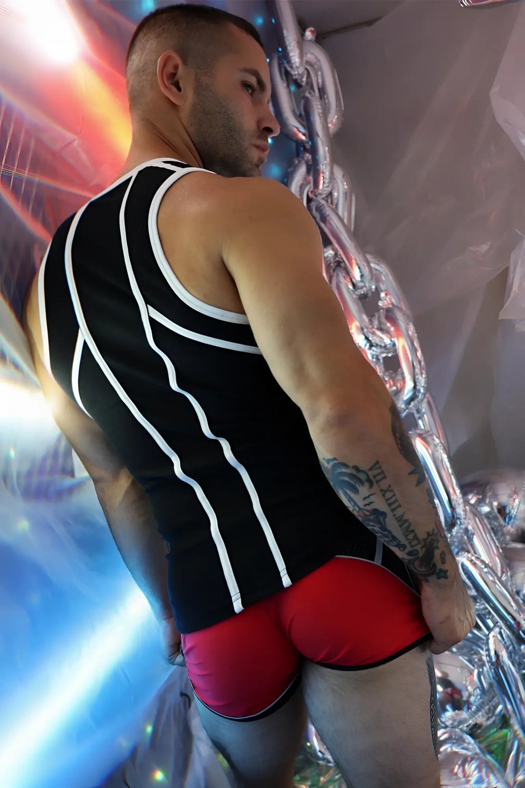 Gymnetixxx tank black and white striped sleeveless top paired with red shorts for active wear