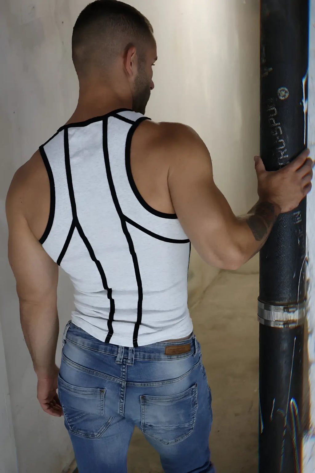 White gymnetixxx tank top with black geometric trim designed for workout and casual wear