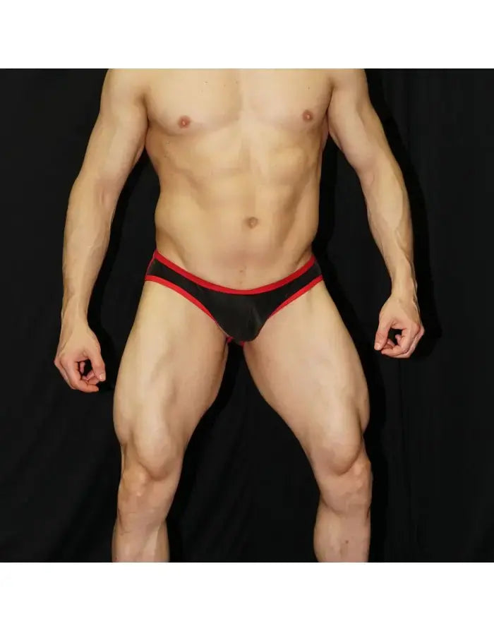 Men's jockstrap in black eco-leather with red waistband featuring a snug fit and minimal coverage shown on a model by Arroyman
