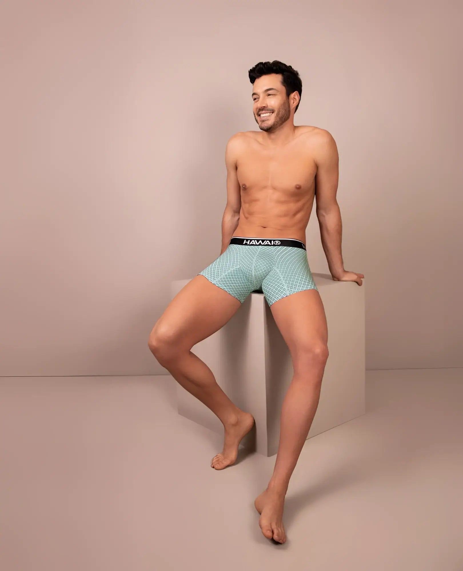 Light blue patterned boxer briefs with a black waistband featuring the Hawaiian brand name in green color