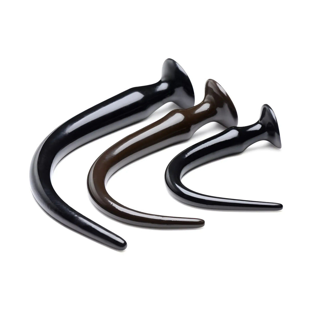 Three glossy black and brown slim tapered anal plugs with flared bases in the hosed slim tapered anal hose training set