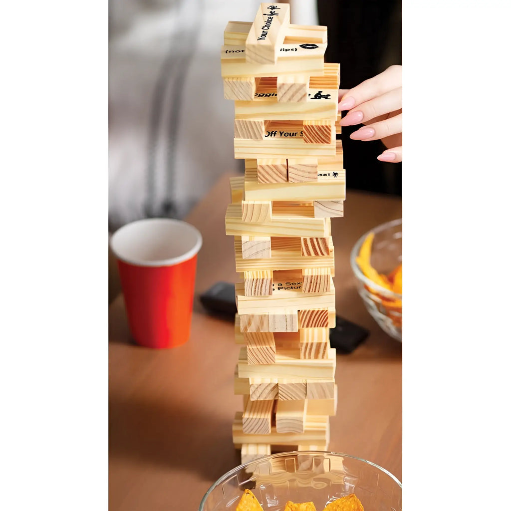 Tall wooden jenga tower with engraved phrases and playful designs in hott products the tower tease stacking game