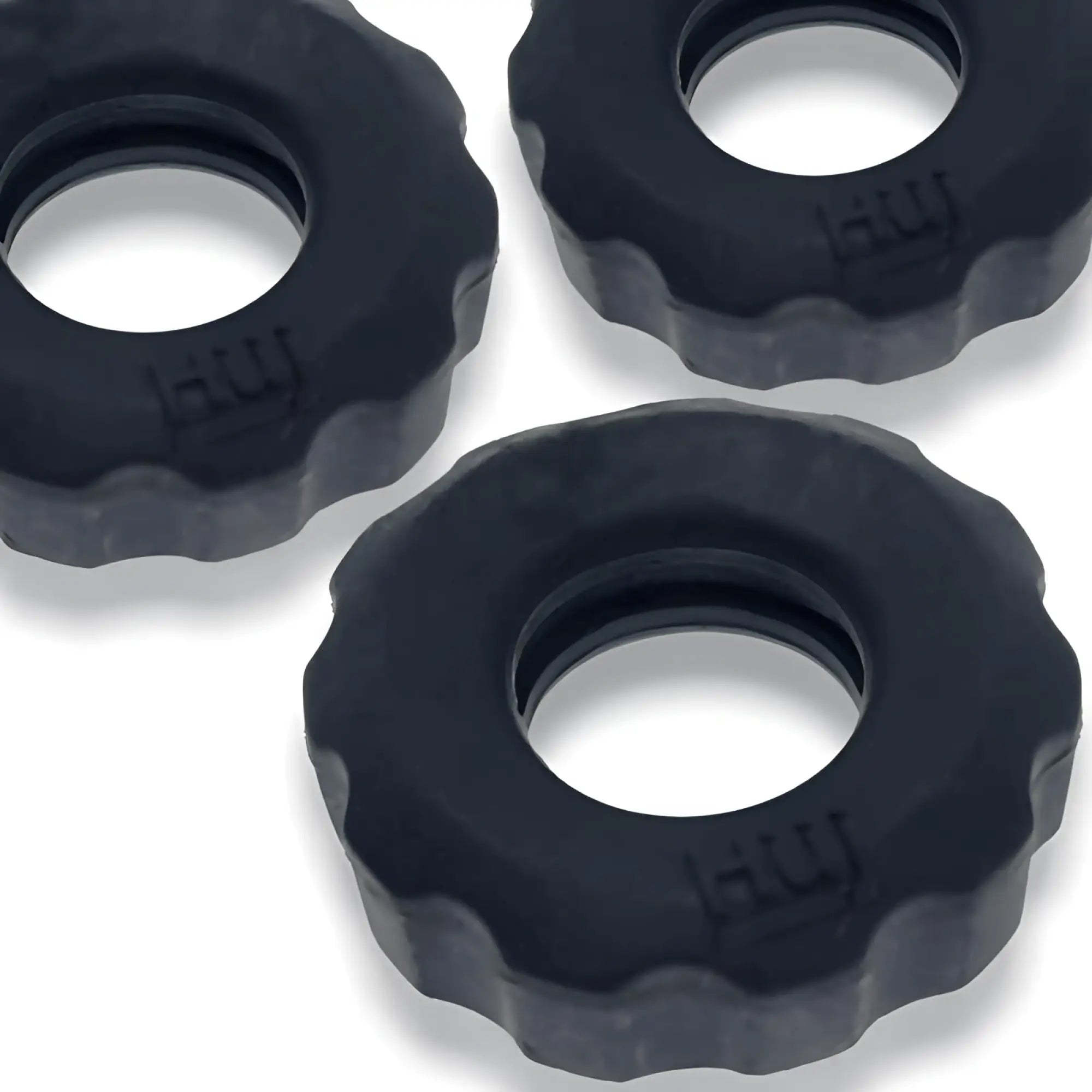 Black textured silicone cockrings with scalloped edge and embossed hui branding from hunkyjunk super hunkyjunk set