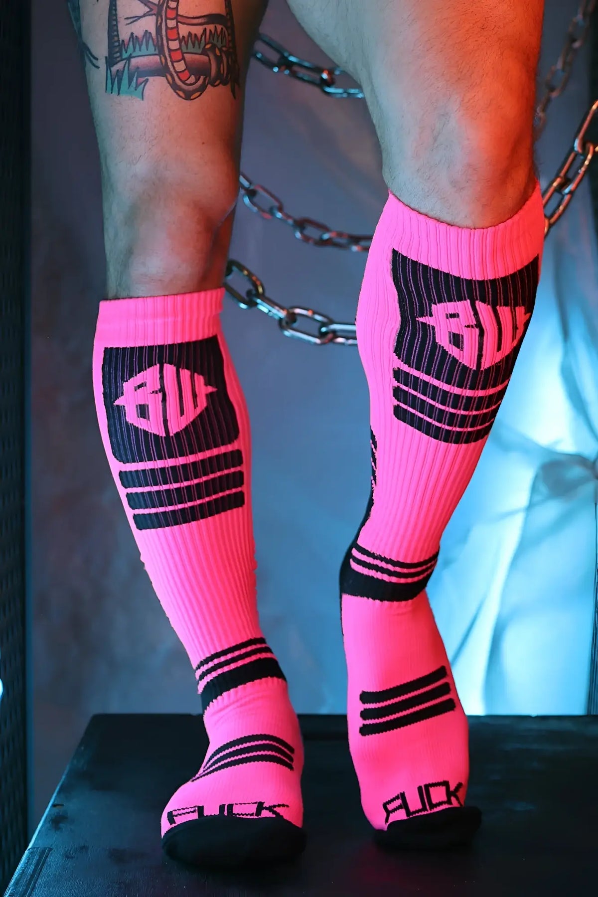 Hypnotix socks bright pink knee-high athletic socks with black ribbed panels and bold bulk branding on leg and toe