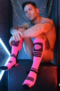 Hypnotix socks bright pink knee-high socks with black stripes and bold logo on the side for stylish comfort