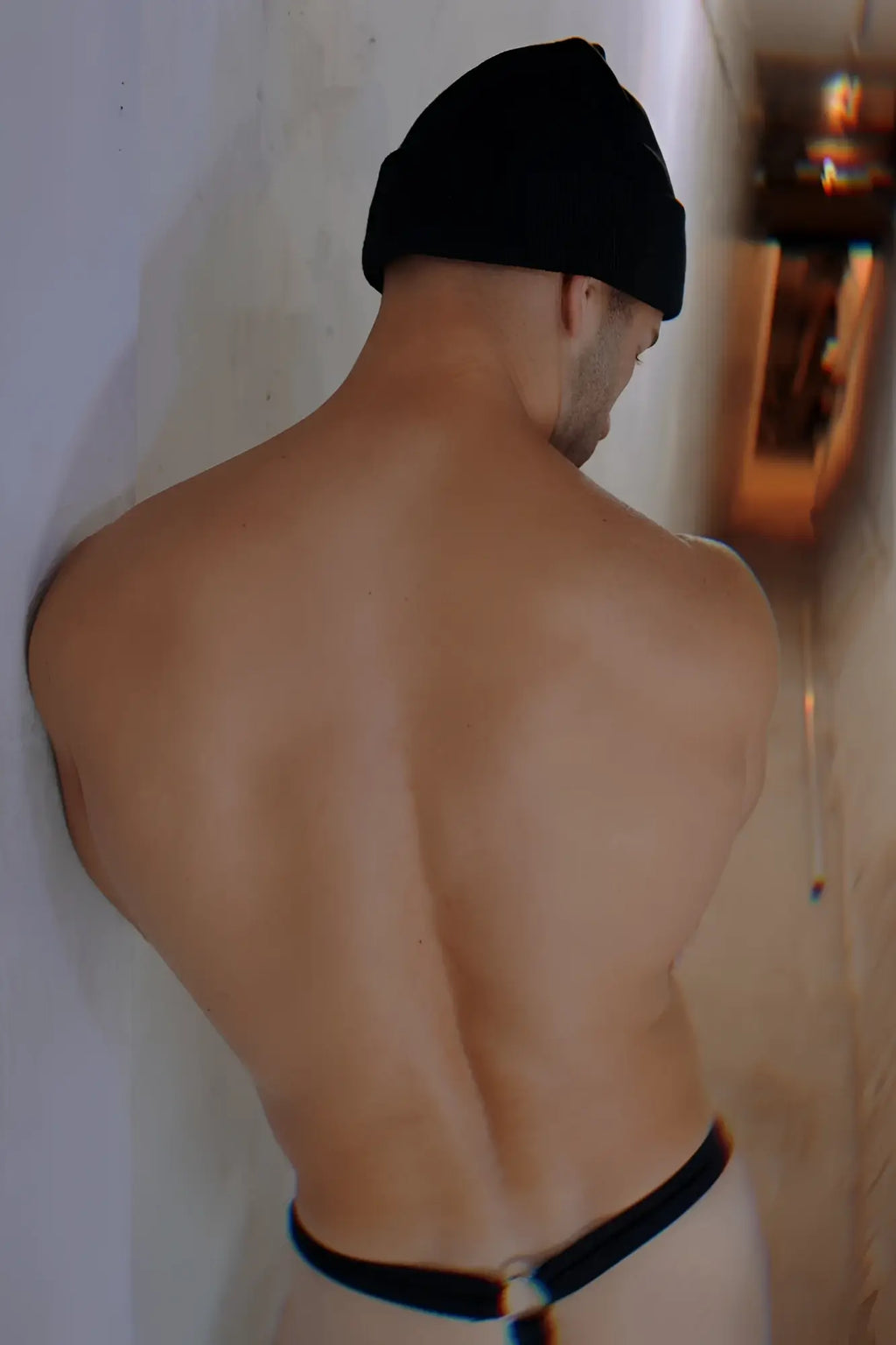 Black Iconixxx beanie made of soft material shown from the back on a man with a muscular build