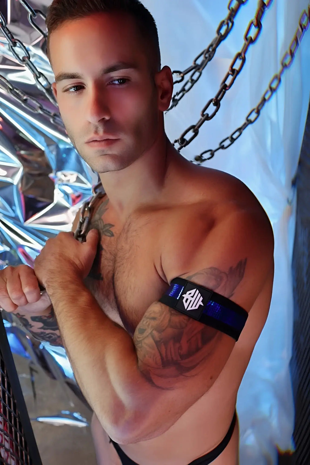 Black illuminator armband with white logo and blue accent stripe designed for visibility and comfort during exercise