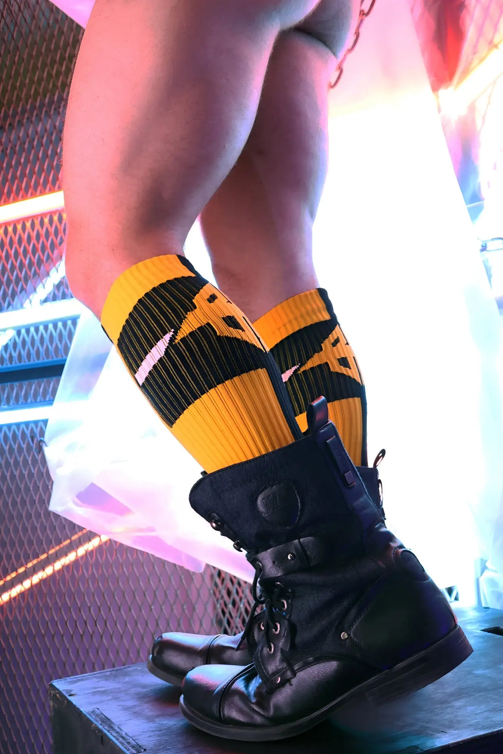 Black leather combat boots with sturdy design and visible laces featured with infinity socks product display