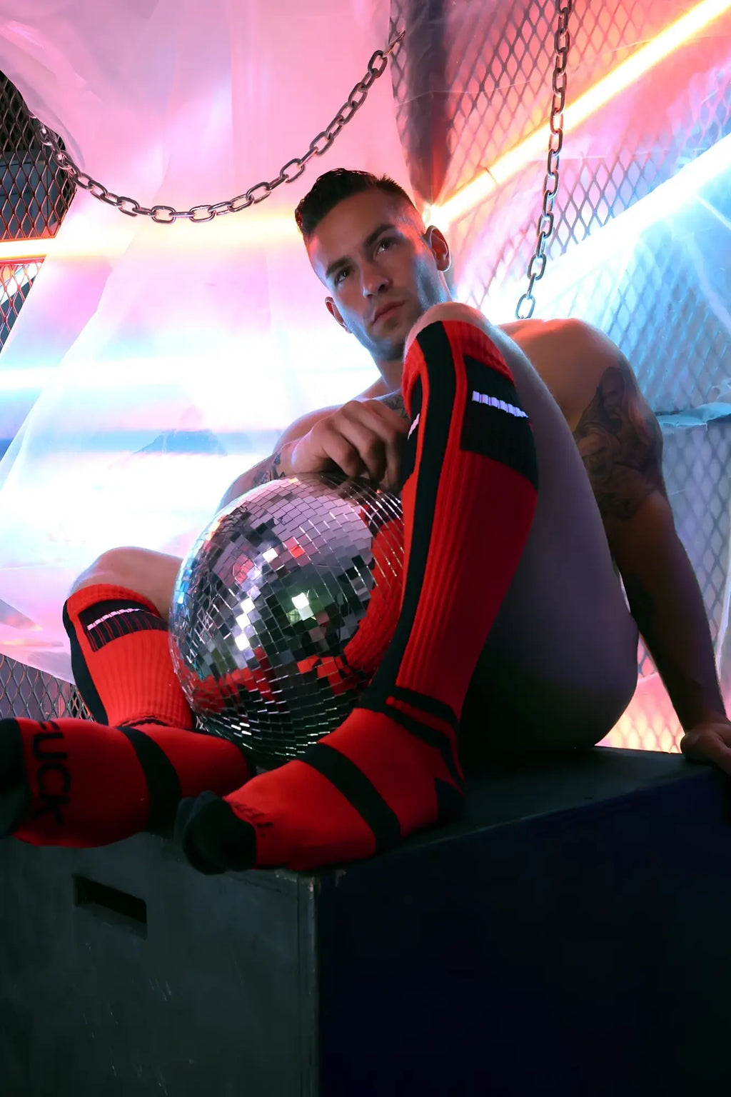 A reflective silver disco ball with mosaic mirrored facets featured in infinity socks product imagery