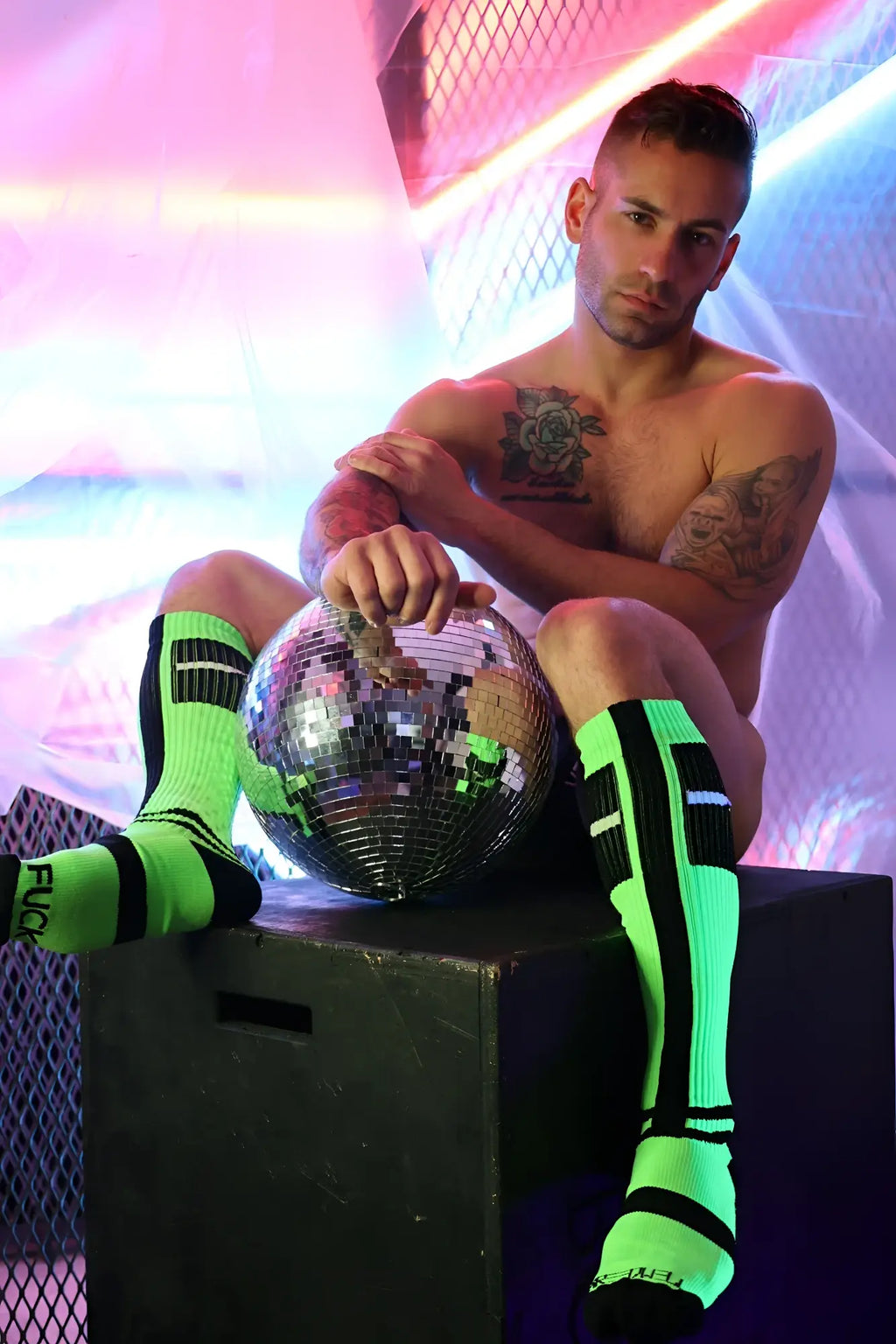 A reflective spherical disco ball with a mirrored mosaic surface for infinity socks decoration or display