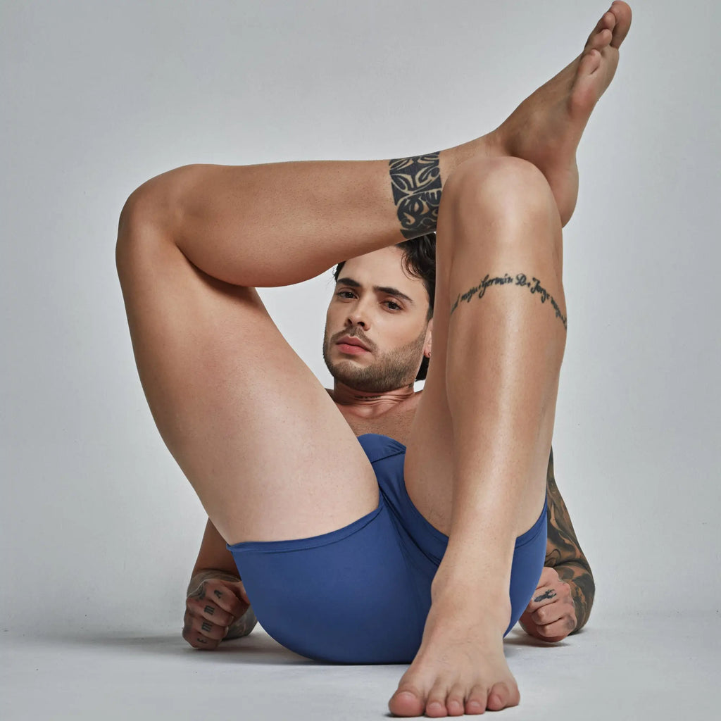 A man wearing blue seamless fitted athletic shorts in intymen ing092 boxer design showing the front side